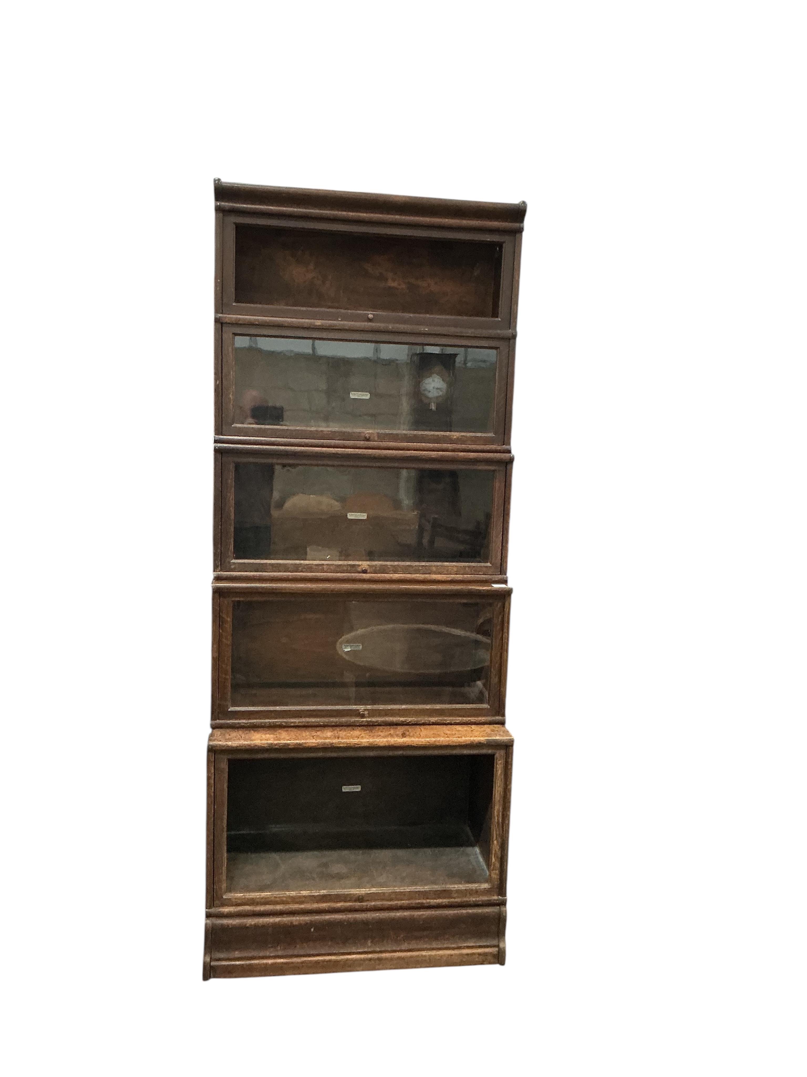 A Globe Wernicke oak five section bookcase, two sections missing glass panels, width 86cm, depth 46cm, height 220cm